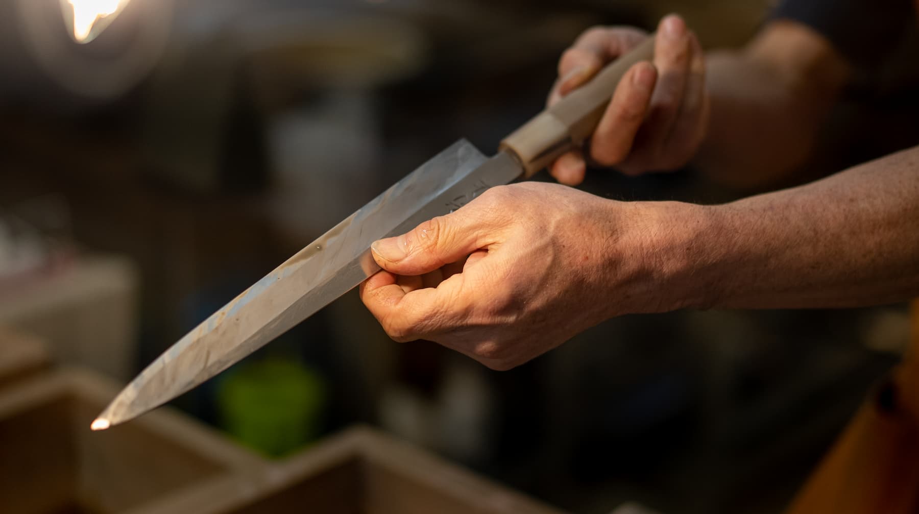 Master Hirose checking the edge on a yanagi knife